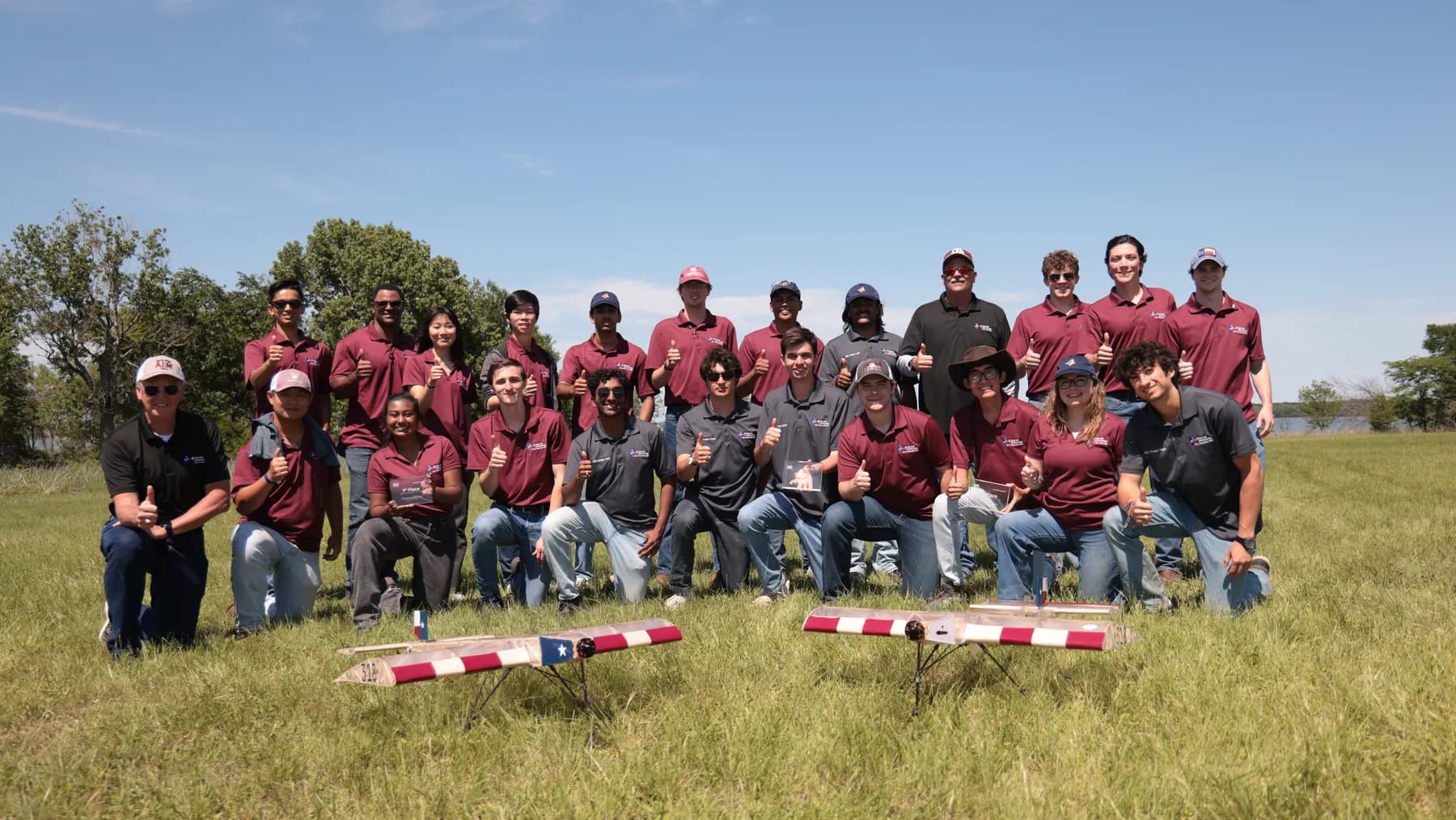 The Texas A&M SAE Aero Design team with two aircraft