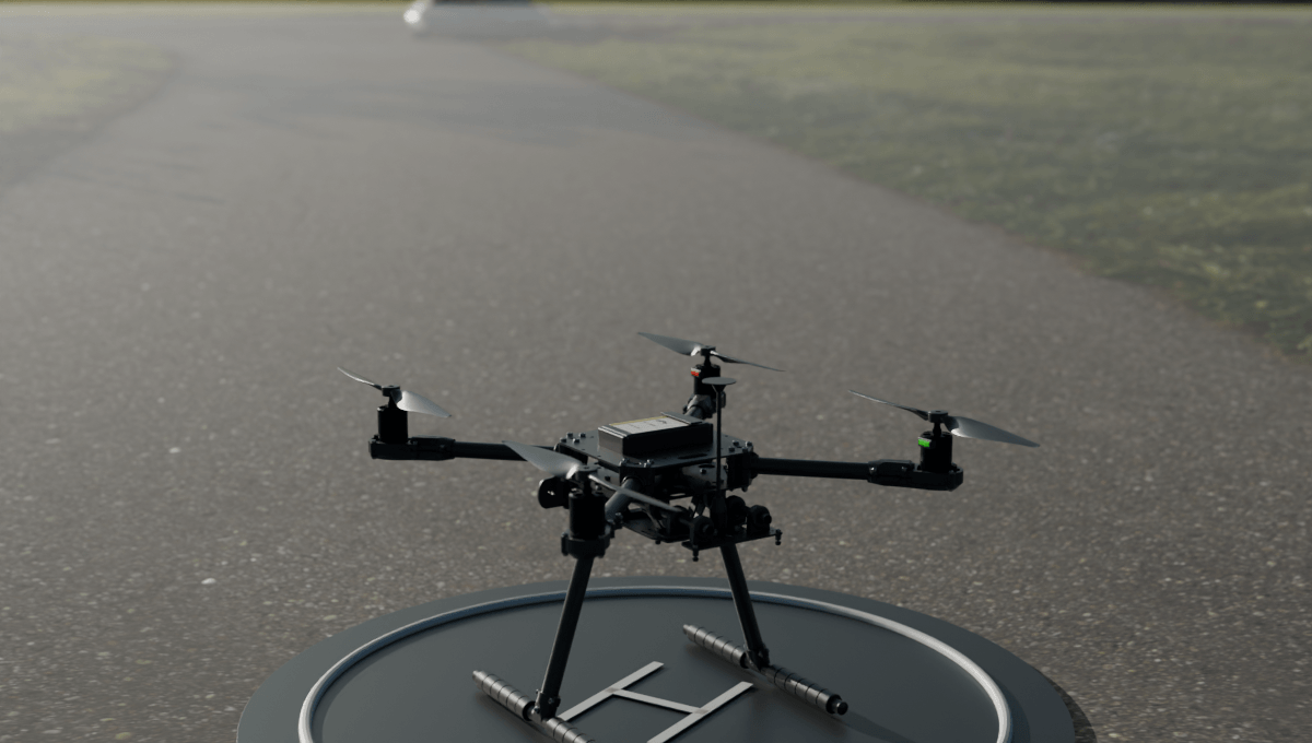 Quadcopter with black motor mounts and red and green navigation lights on a landing pad in a photographed outdoor environment