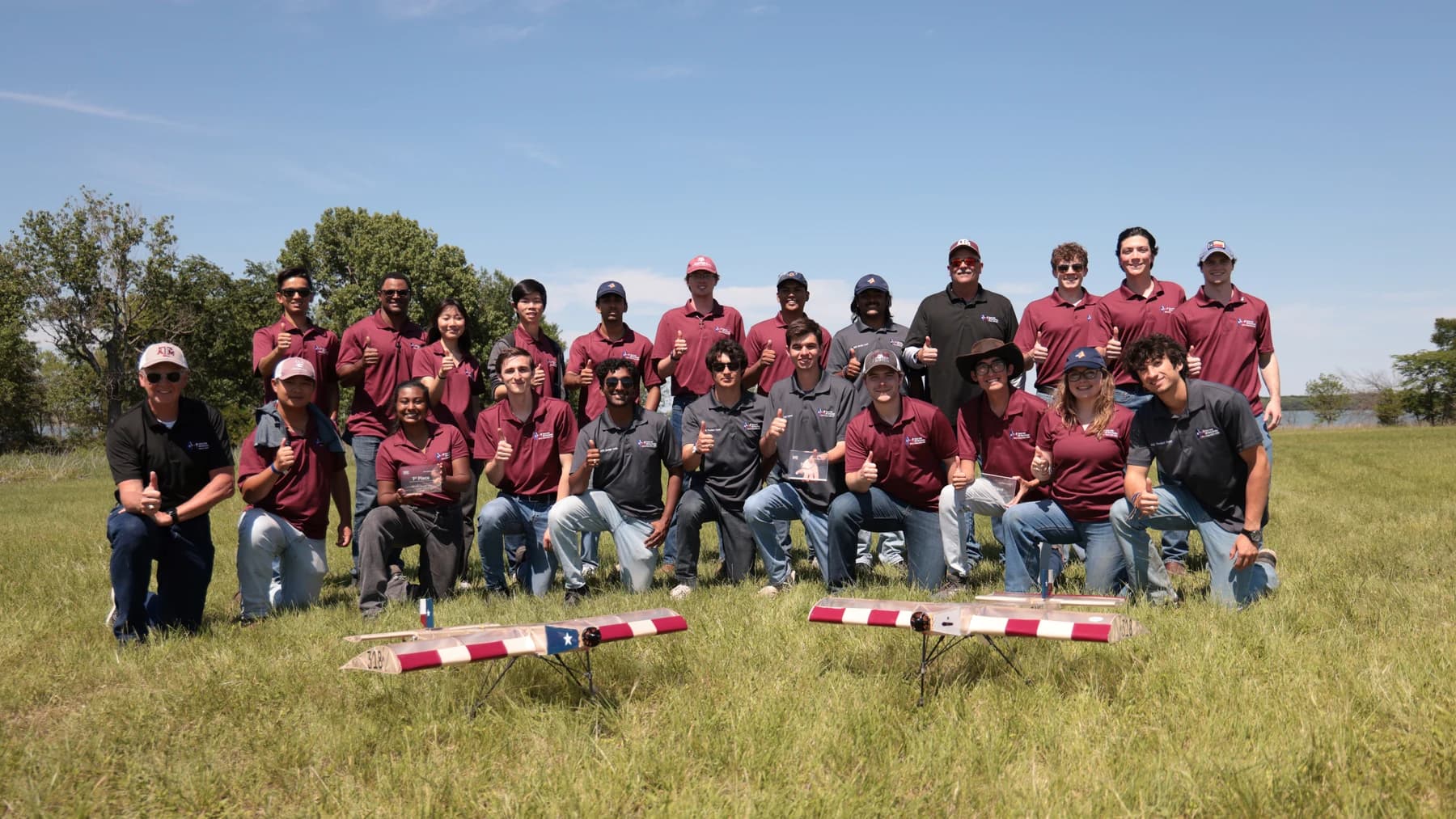 The Texas A&M SAE Aero Design team with their aircraft at the field
